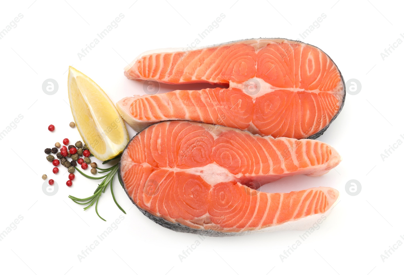 Photo of Fresh raw salmon steaks and spices isolated on white, top view