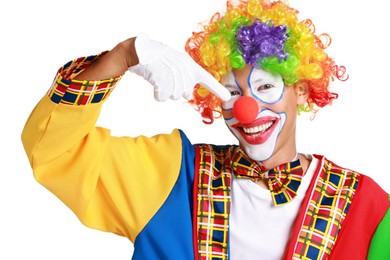 Portrait of happy clown pointing at his nose on white background