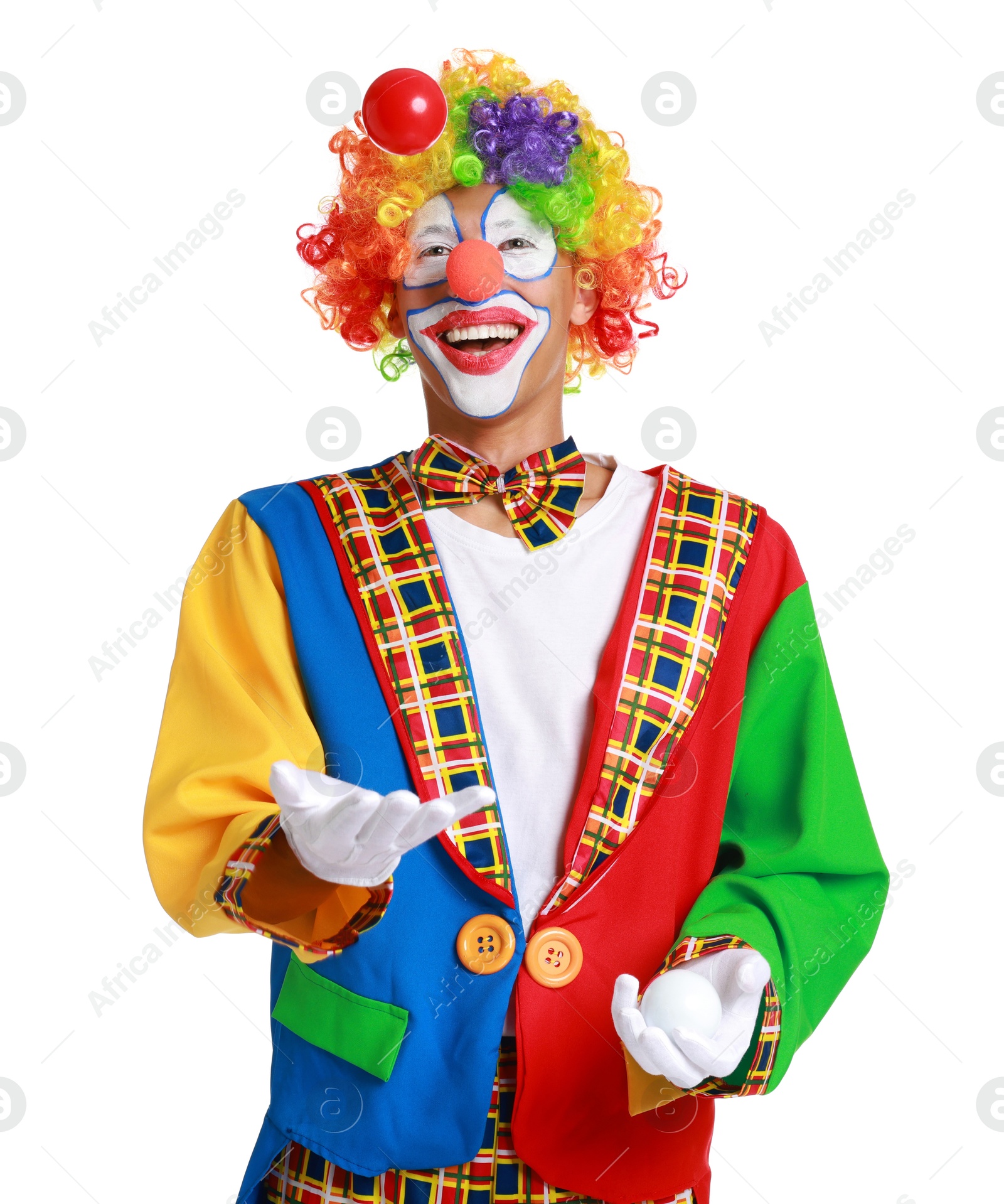 Photo of Happy clown juggling balls on white background