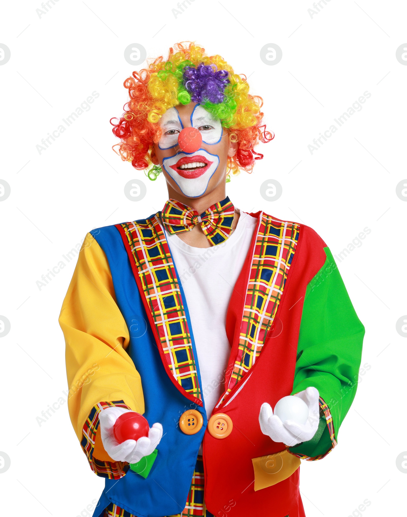 Photo of Happy clown juggling balls on white background