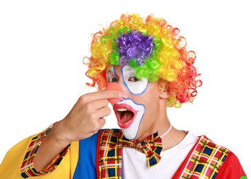 Portrait of emotional clown beeping his nose on white background