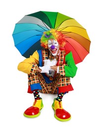 Photo of Happy clown with colorful umbrella on white background