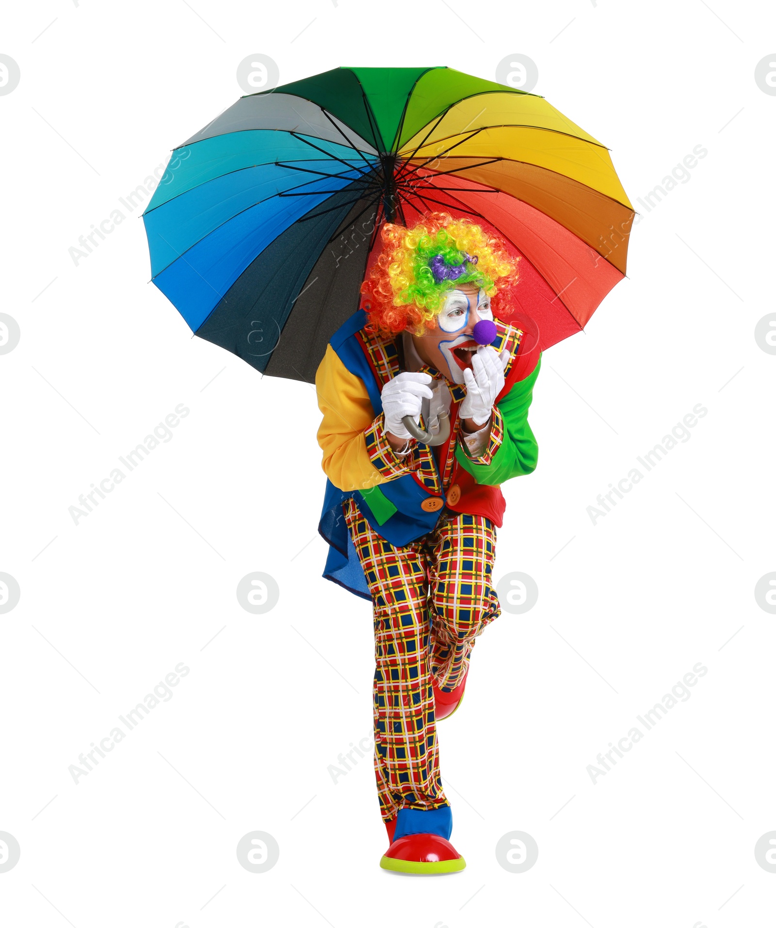 Photo of Emotional clown with colorful umbrella on white background