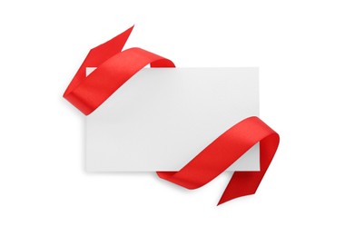 Photo of Blank card and red ribbon isolated on white, top view