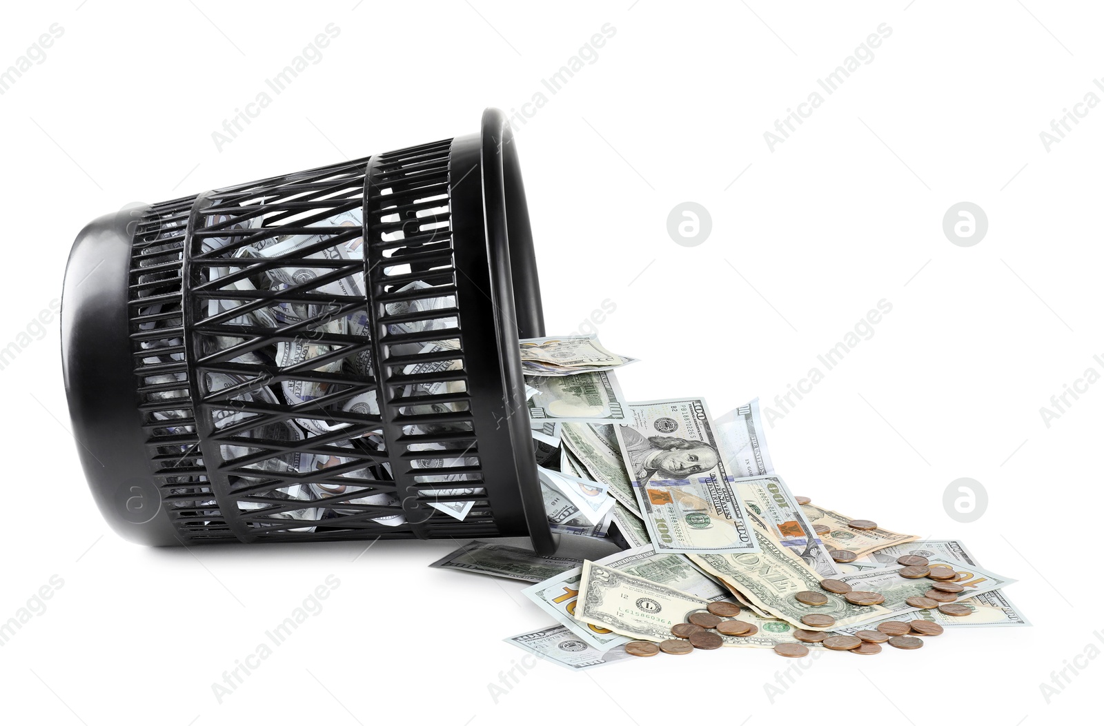 Photo of Many dollar banknotes, coins and overturned trash bin isolated on white