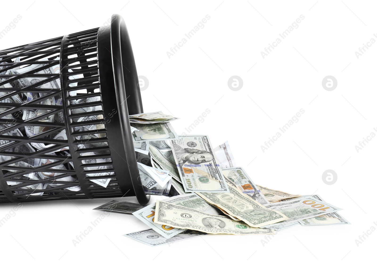 Photo of Many dollar banknotes and overturned trash bin isolated on white