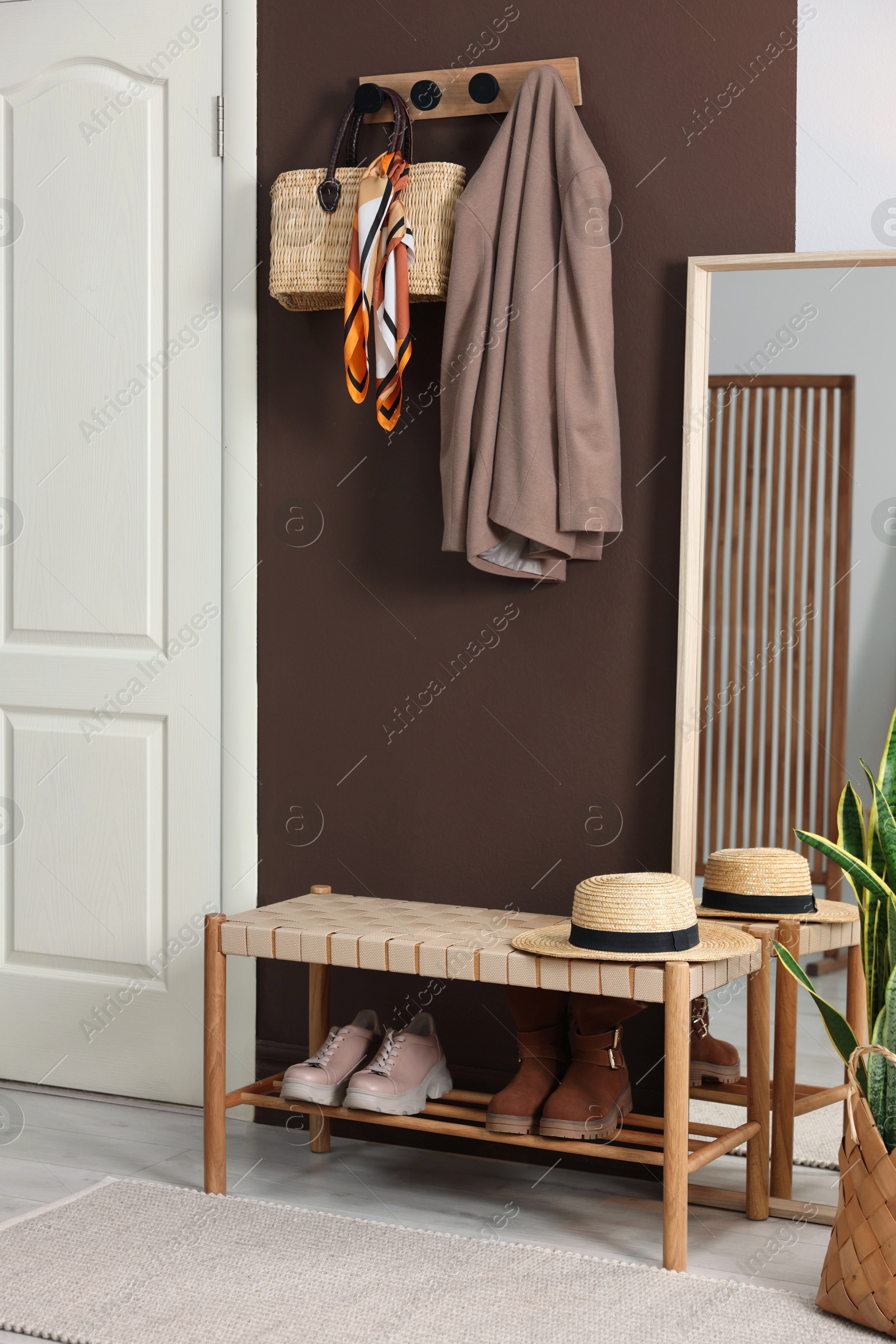 Photo of Stylish hallway interior with coat rack and mirror