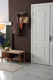 Photo of Stylish hallway interior with coat rack and mirror