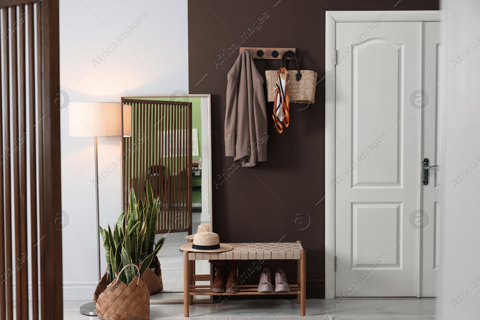 Photo of Stylish hallway interior with coat rack and mirror