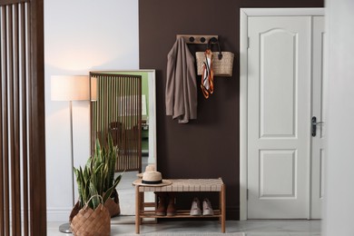 Photo of Stylish hallway interior with coat rack and mirror