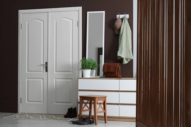 Photo of Stylish hallway interior with coat rack and mirror