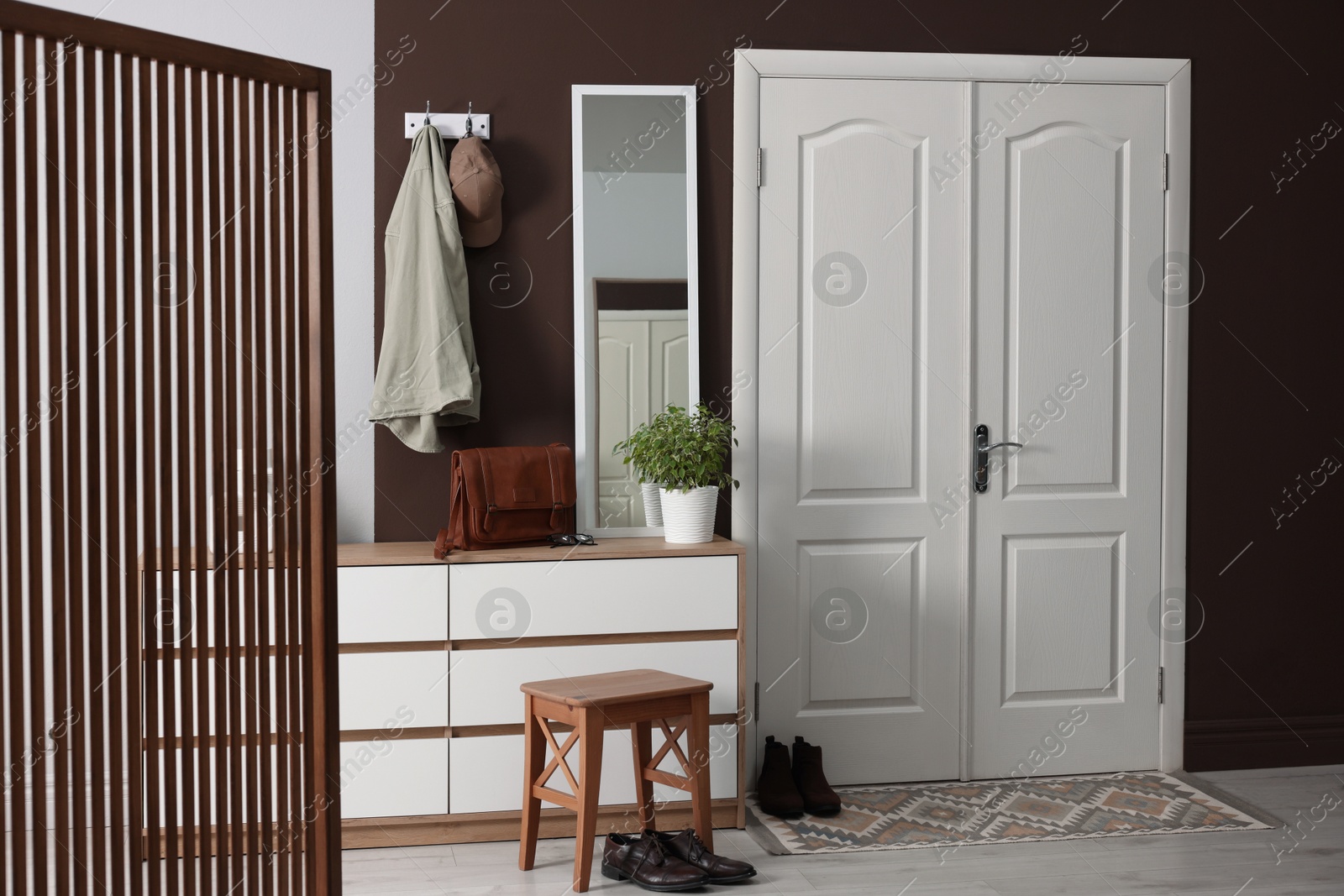 Photo of Stylish hallway interior with coat rack and mirror