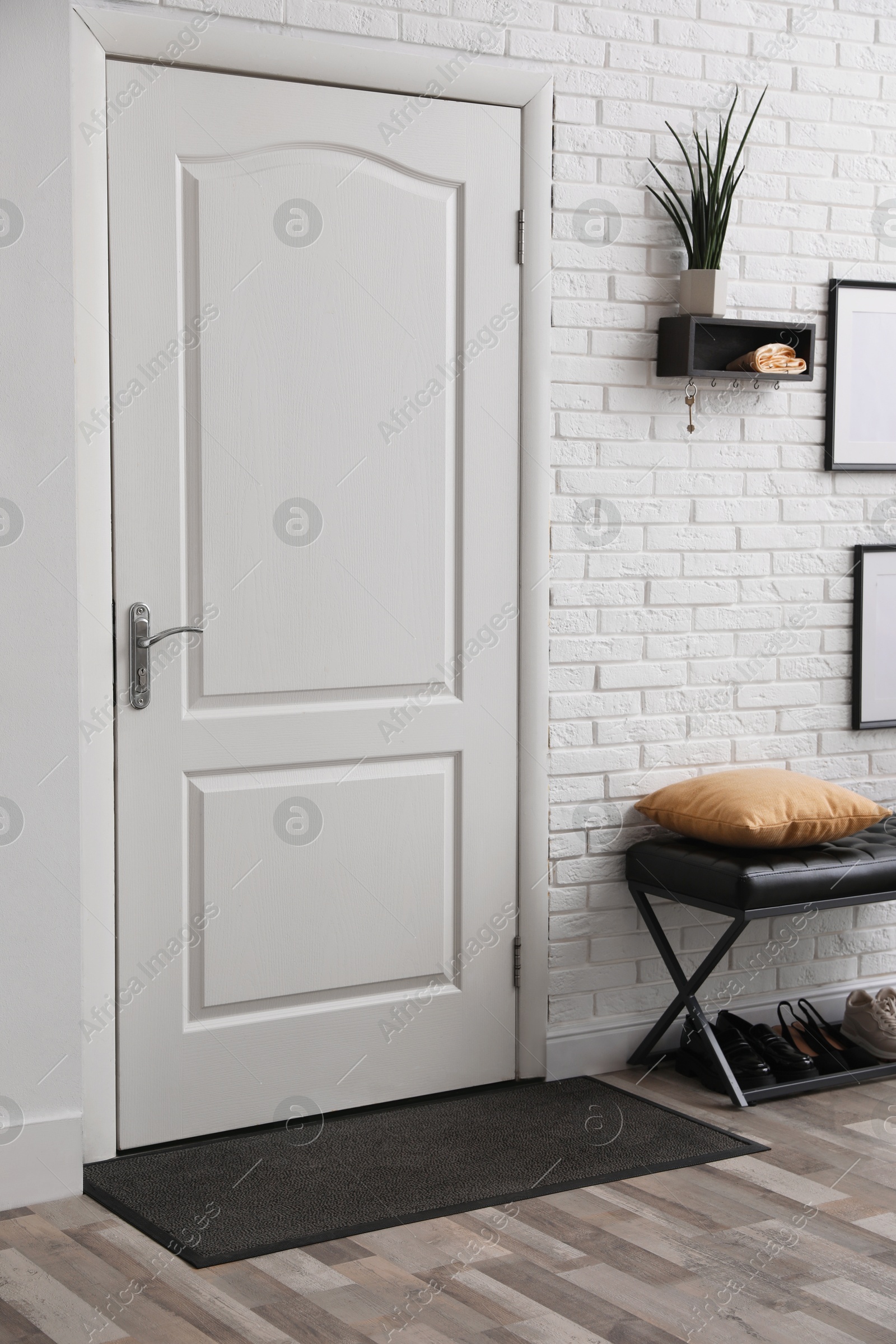 Photo of Stylish hallway interior with bench and houseplant