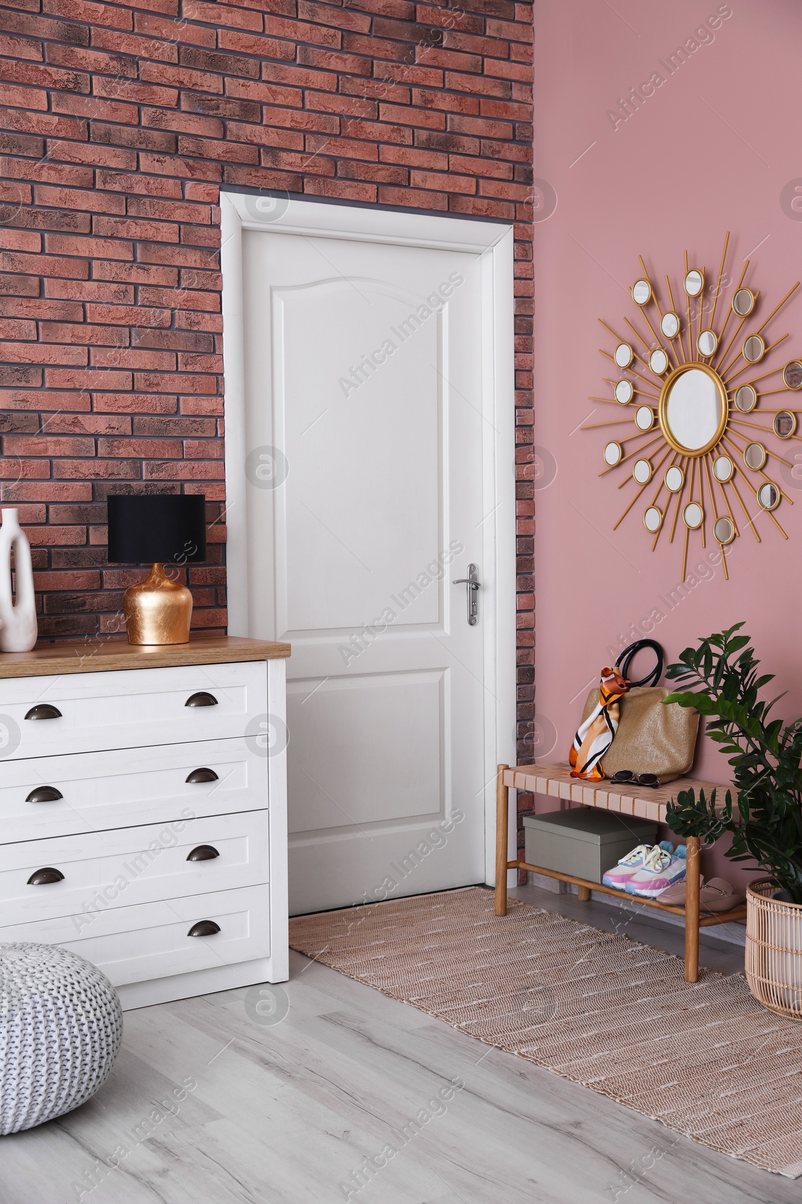 Photo of Stylish hallway interior with chest of drawers and bench