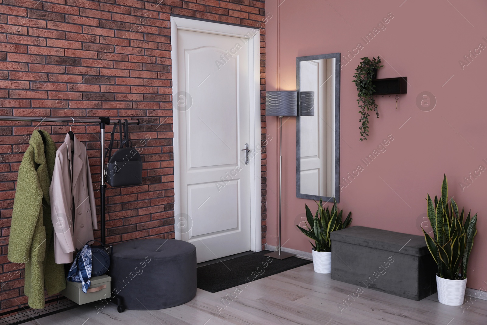 Photo of Stylish hallway interior with coat rack and mirror