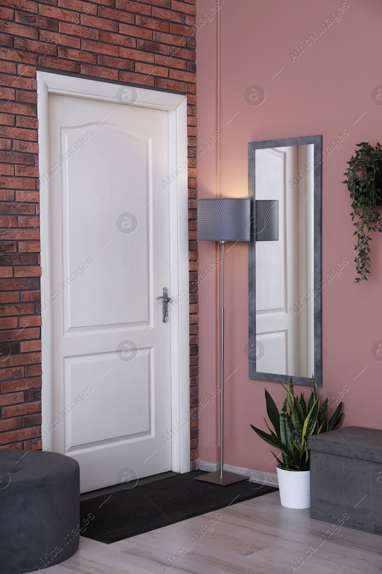 Photo of Stylish hallway interior with mirror and pouf