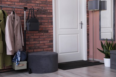 Photo of Stylish hallway interior with coat rack and mirror