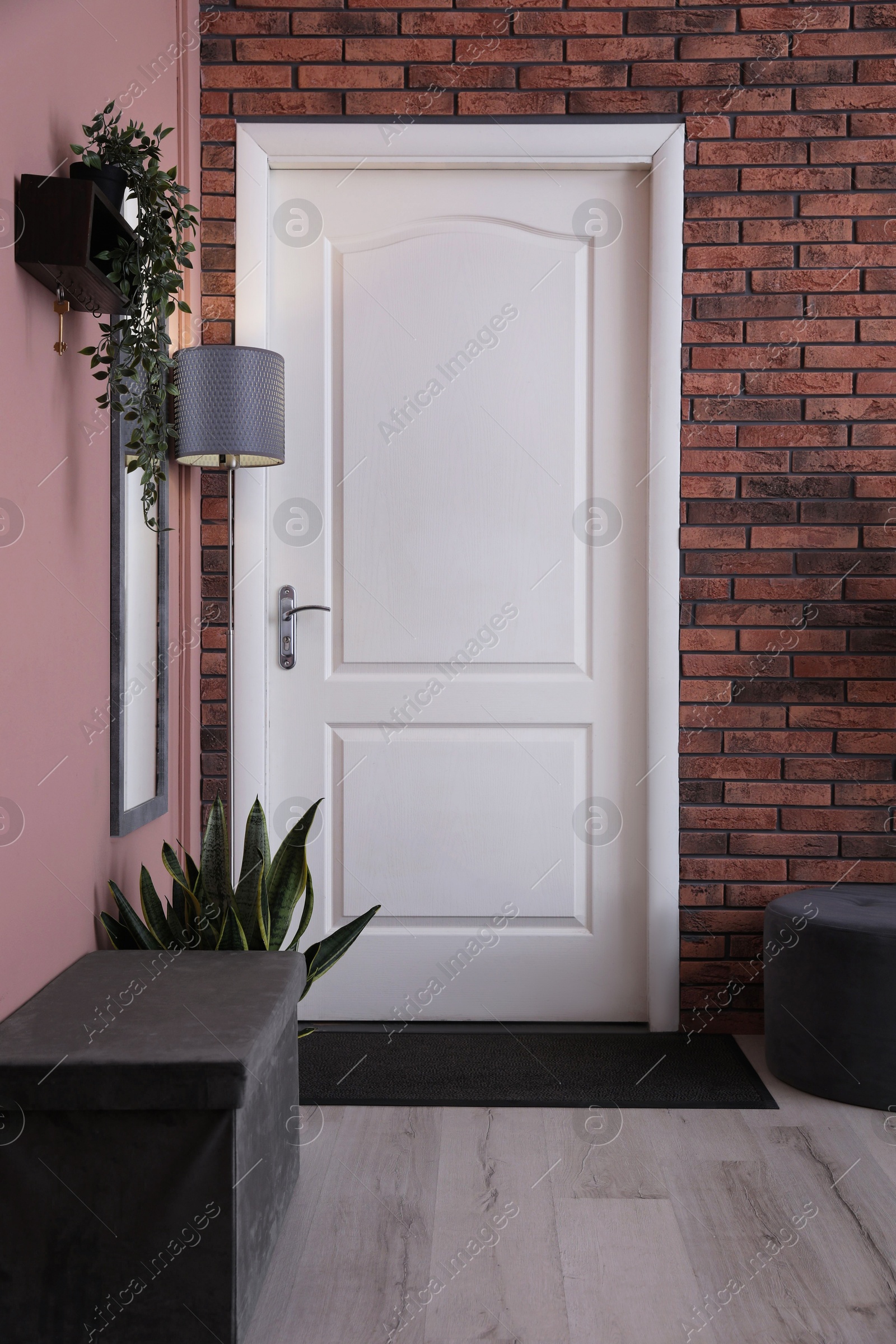 Photo of Stylish hallway interior with mirror and lamp