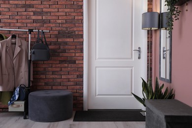 Stylish hallway interior with coat rack and mirror