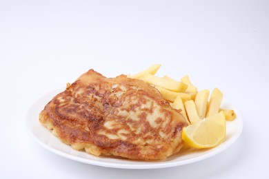 Photo of Tasty fish in soda water batter, potato chips and lemon slice isolated on white