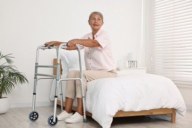 Senior woman with walking frame in hospital ward