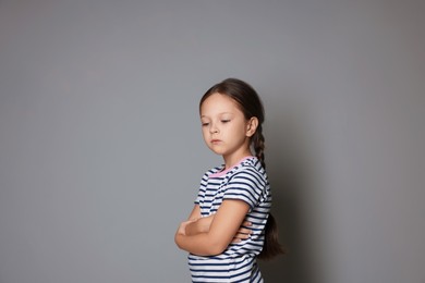 Photo of Orphanage concept. Sad girl on gray background