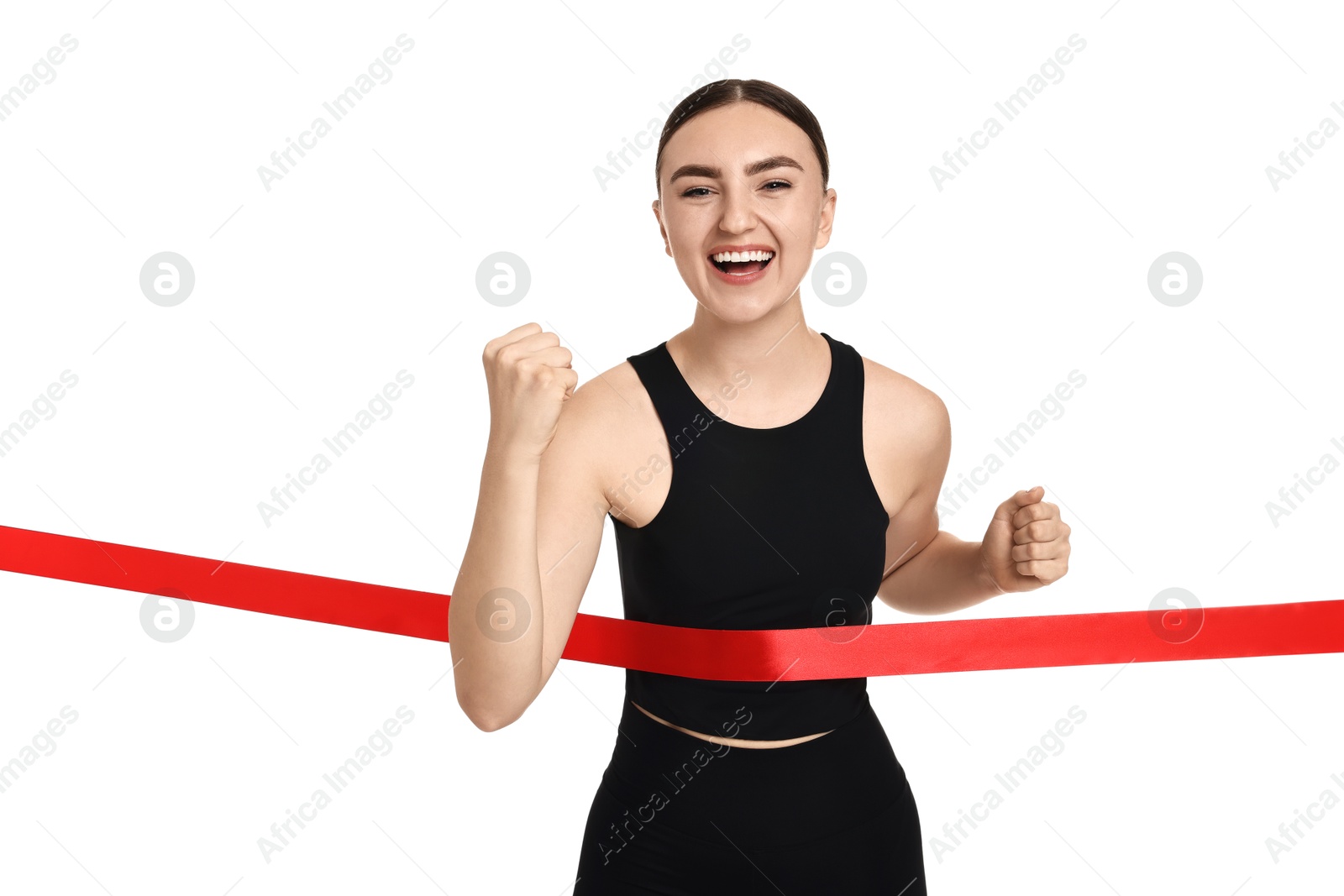 Photo of Beautiful woman in sportswear crossing red finish line on white background