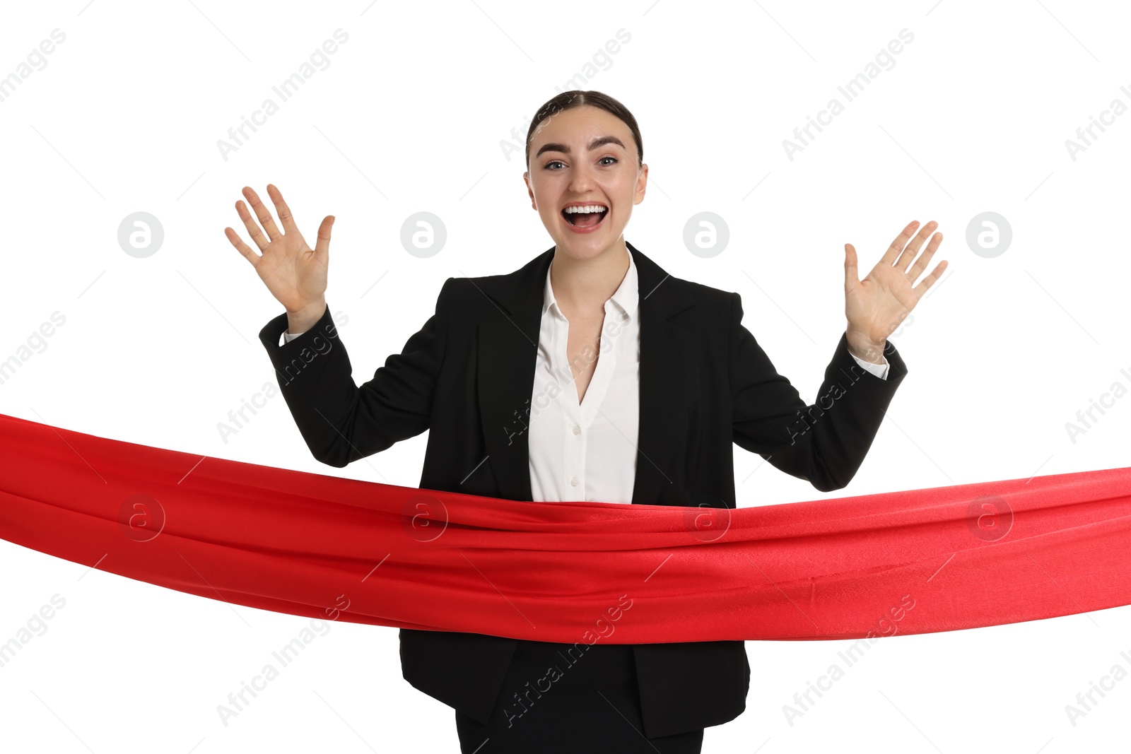 Photo of Young businesswoman in suit crossing red finish line on white background