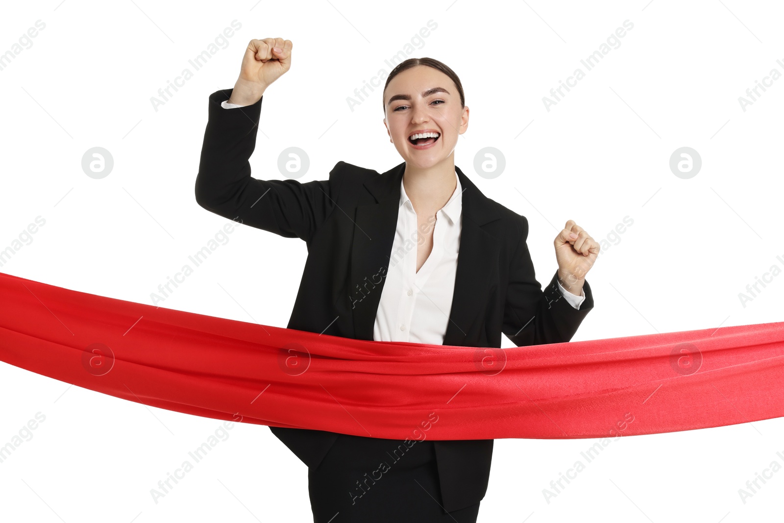 Photo of Young businesswoman in suit crossing red finish line on white background