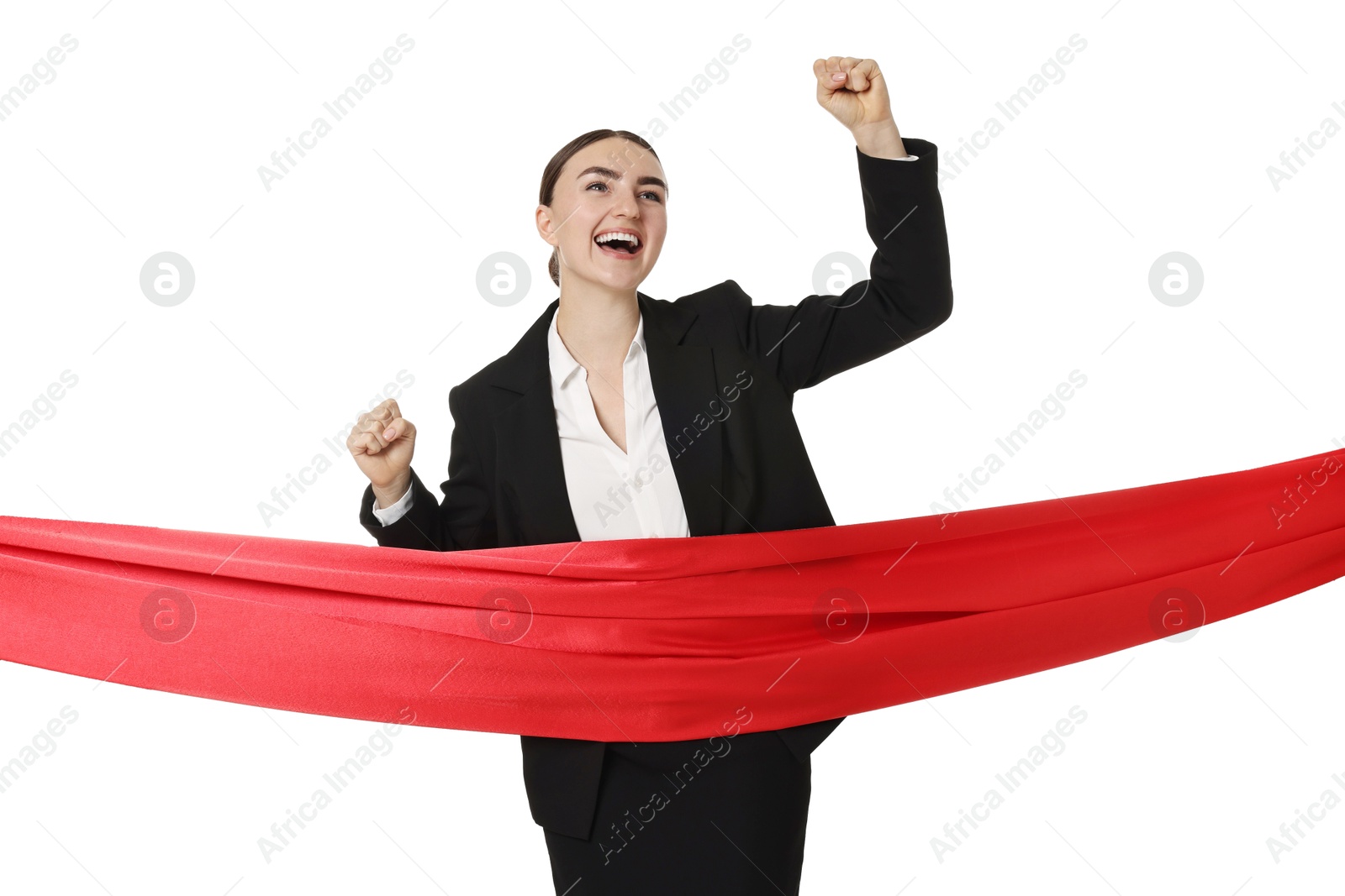 Photo of Young businesswoman in suit crossing red finish line on white background