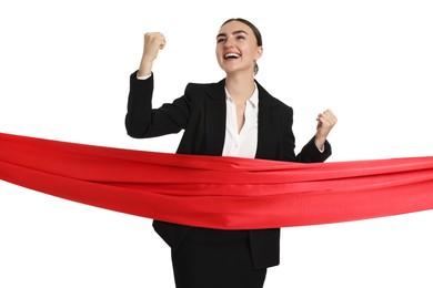 Photo of Young businesswoman in suit crossing red finish line on white background