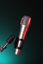 Photo of Stand with microphone on dark background. Sound recording and reinforcement