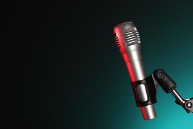 Photo of Stand with microphone on dark background, space for text. Sound recording and reinforcement