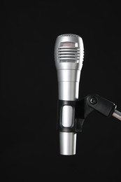 Photo of Stand with microphone on black background. Sound recording and reinforcement