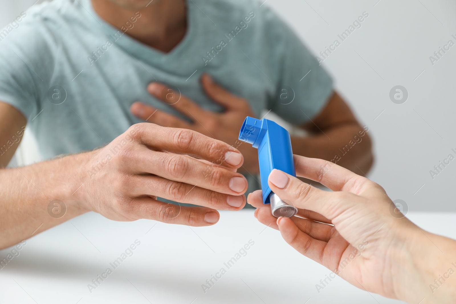 Photo of Man getting inhaler indoors, closeup. Asthma treatment