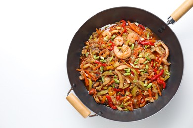 Stir-fry sea food in wok on white background, top view. Space for text