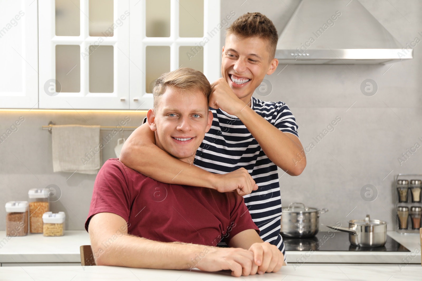 Photo of Family portrait of happy brothers in kitchen