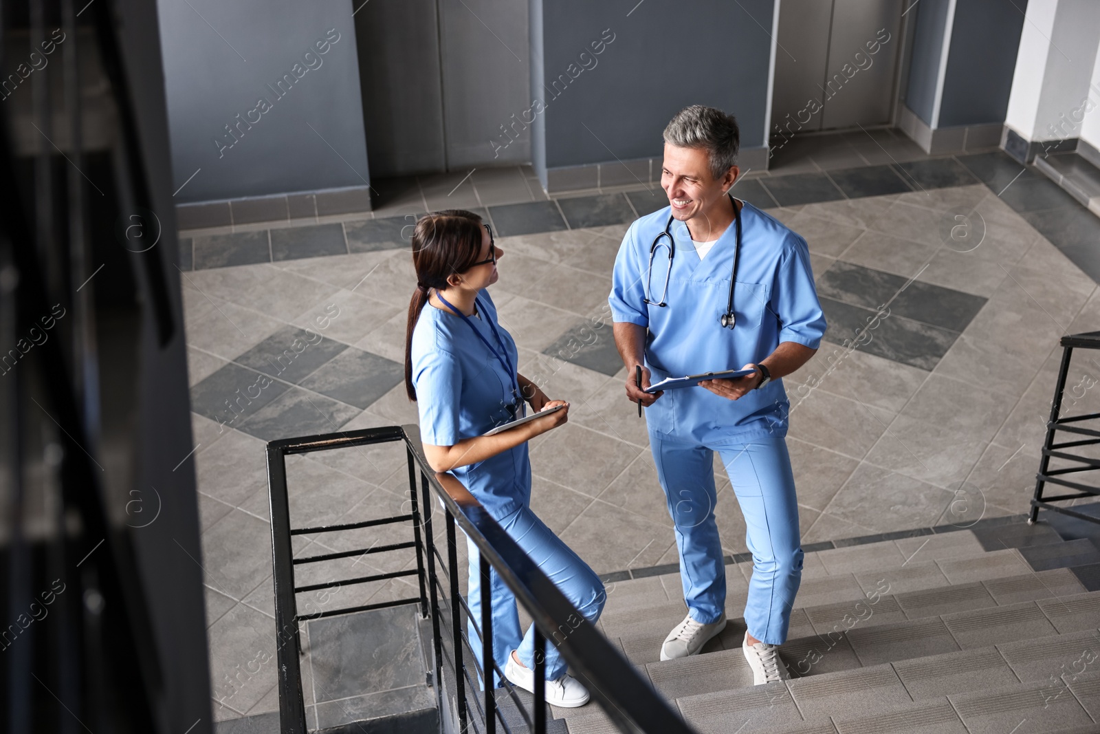 Photo of Healthcare workers talking on stairs in hospital