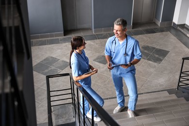 Healthcare workers talking on stairs in hospital