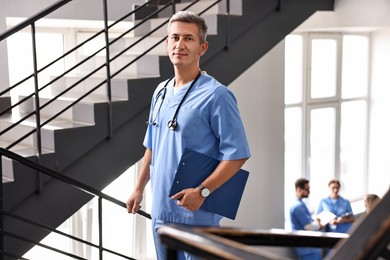 Healthcare worker with stethoscope and clipboard in hospital