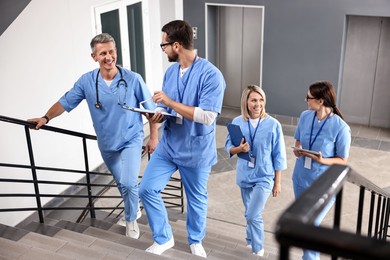 Healthcare workers walking up stairs in hospital