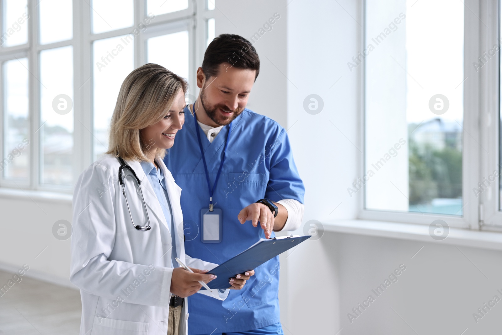 Photo of Healthcare workers with clipboard in hospital. Medical service