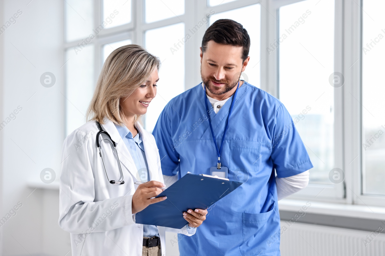 Photo of Healthcare workers with clipboard in hospital. Medical service