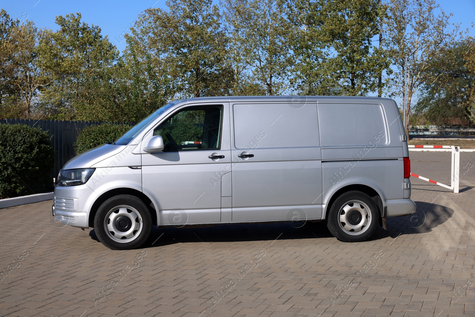 Photo of One gray minibus outdoors on sunny day