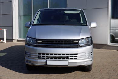 Photo of One gray minibus outdoors on sunny day