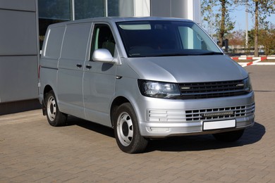 Photo of One gray minibus outdoors on sunny day