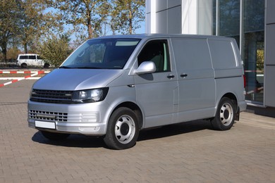 Photo of One gray minibus outdoors on sunny day