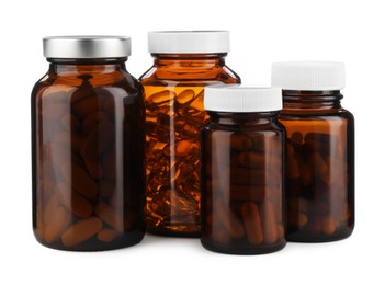 Photo of Medical bottles with pills isolated on white