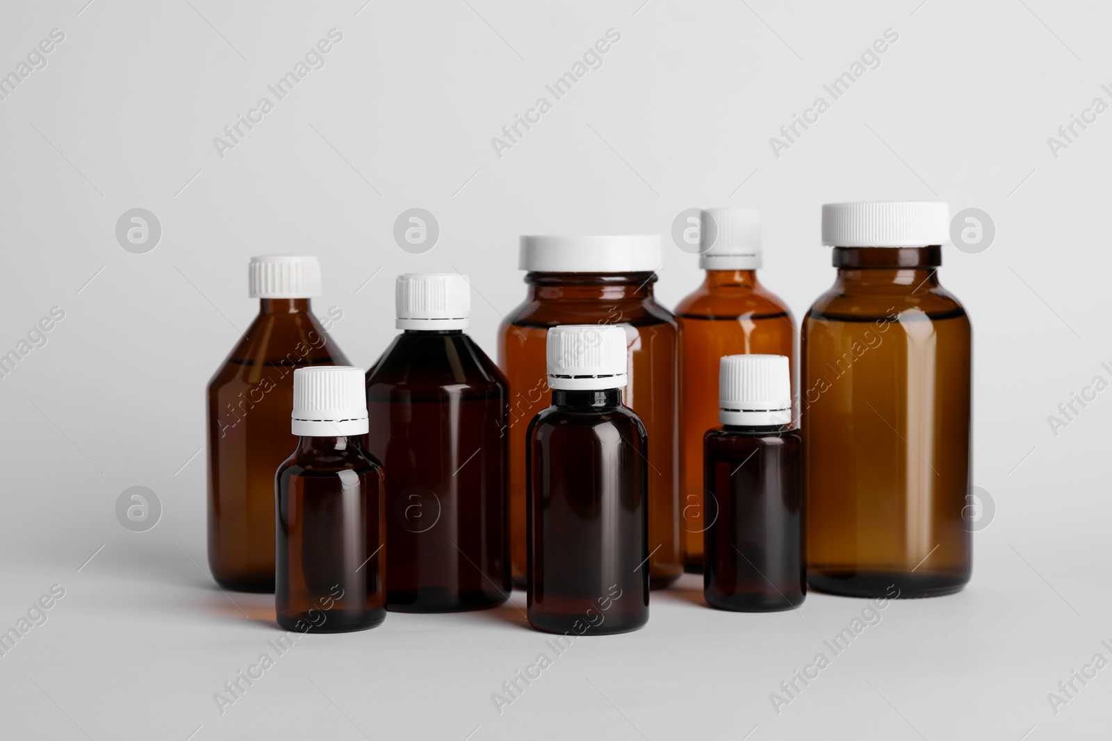 Photo of Medical bottles with medicine on white background