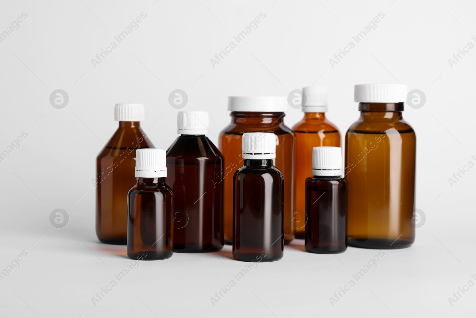 Photo of Medical bottles with medicine on white background